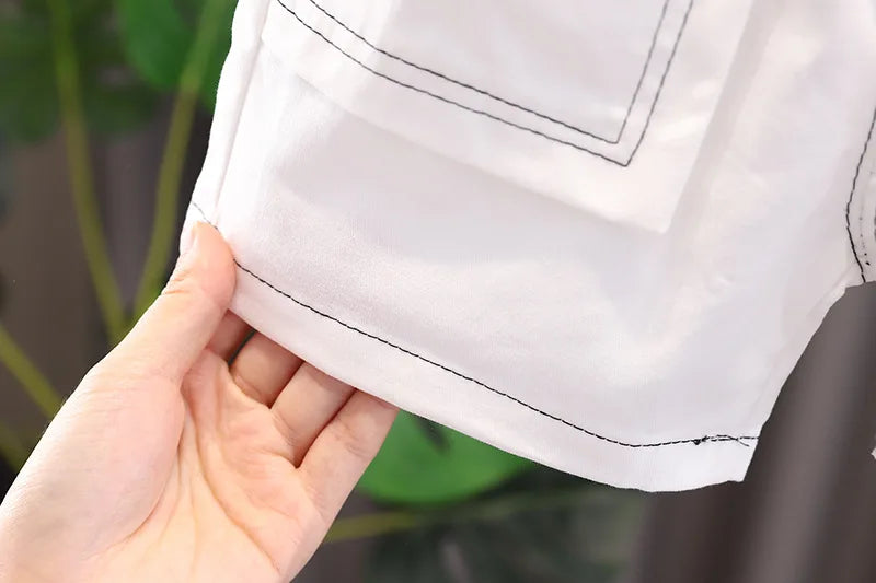 Conjunto de roupas de verão fofo de dinossauro com estampa de desenho animado infantil, camiseta com gola redonda + shorts + bolsa para bebês meninos e meninas, novos agasalhos infantis